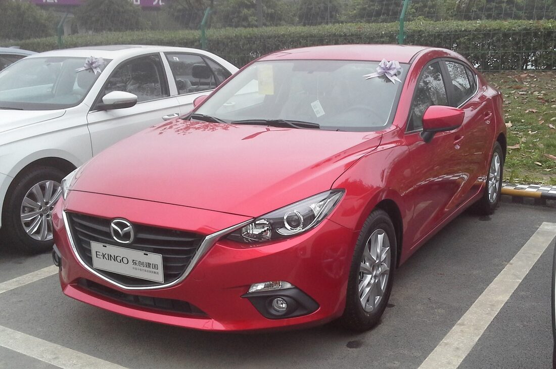 Red Mazda3 (BM) sedan, front three-quarter