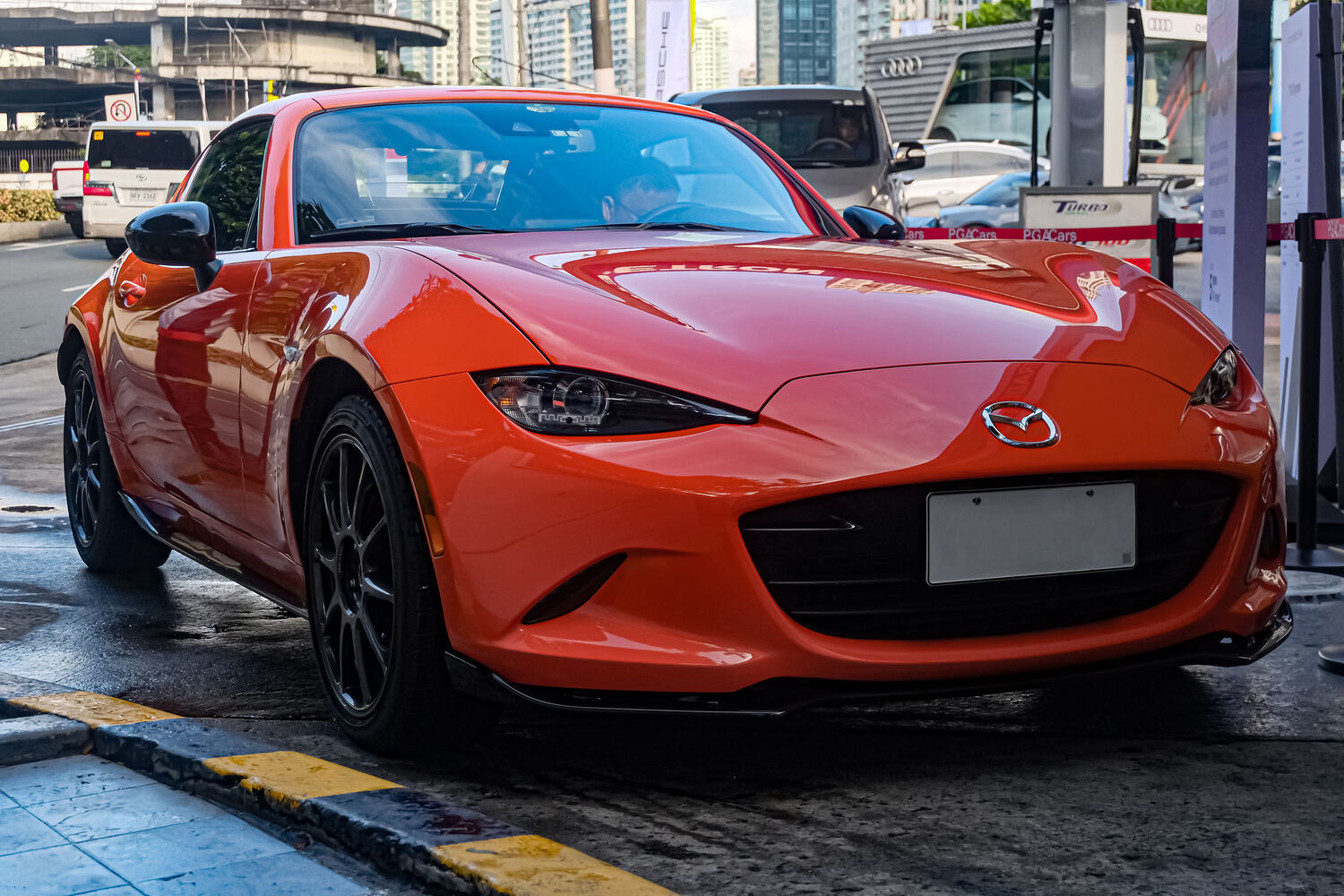 2019 Mazda MX-5 RF 30th Anniversary Edition in Racing Orange with dark forged RAYS wheels, front three-quarter view