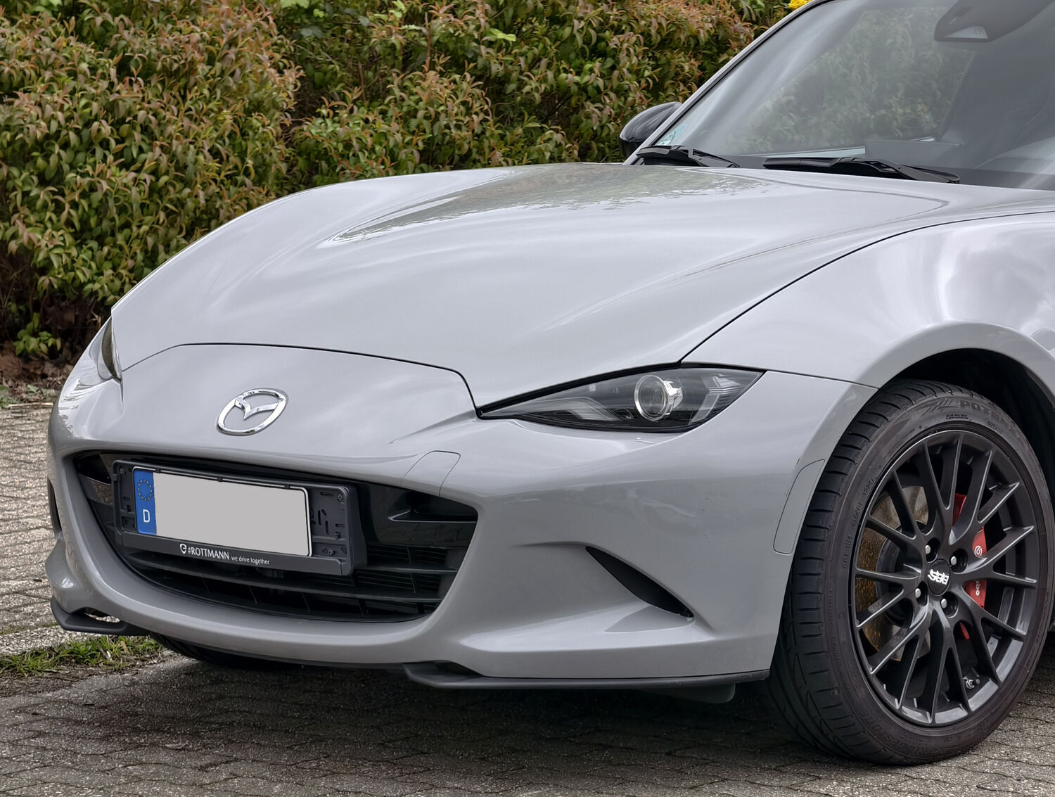2024+ Mazda MX-5 ND3 front detail showing the revised LED headlight and DRL signature and new wheel design